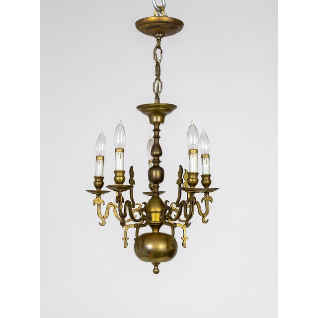 A 19th century Dutch chandelier with Renaissance Revival flame accents. A rich patina on a solid brass, turned-style form...