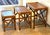 A beautifully crafted set of three vintage nesting tables featuring warm honey-toned rattan construction with rich inset...