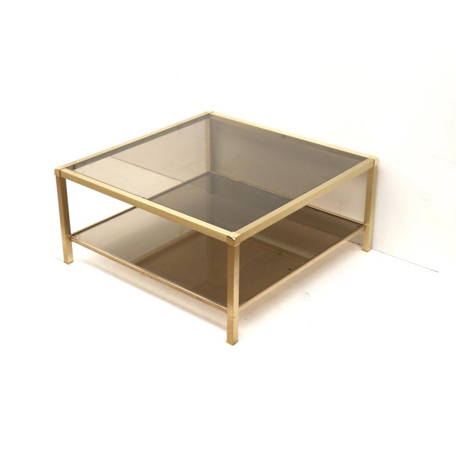 Large Vintage Hollywood Regency Coffee Table in Brass and Smoked Glass, 1970s, in Good conditions. Designed 1970 to 1979