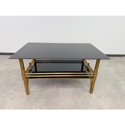 An elegant and highly sophisticated postmodern two-tier coffee table, manufactured in Italy during the 1980s. Designed in...