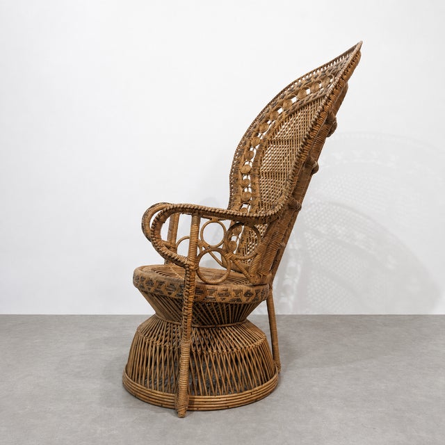 Vintage Peacock chair made of natural woven rattan and wicker, dating from the 1970s. The chair features a tall fan-shaped...