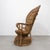 Vintage Peacock chair made of natural woven rattan and wicker, dating from the 1970s. The chair features a tall fan-shaped...