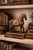 A vintage carved wood horse sculpture decorated with etched metal inlay and detailed saddle ornamentation. The warm aged...