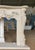 Bursting with theatrical charm and organic elegance, this French Rococo-style fireplace mantle is a masterwork of hand-...