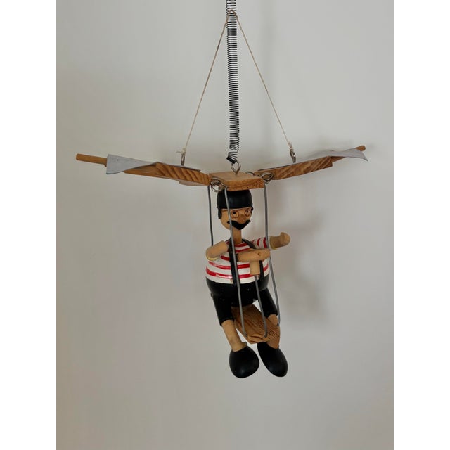 Delightful wooden flying man, hangs and bounces from a spring. Please see condition details noted. Most items found at Pub...