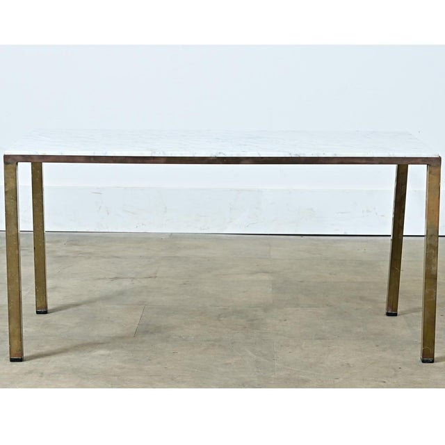 This vintage French coffee table is made from a single slab of Carrara marble with stunning light grey veining against a...