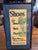 For your consideration is an exceptional, grand-scale piece of authentic 1920s American advertising. This framed retail...