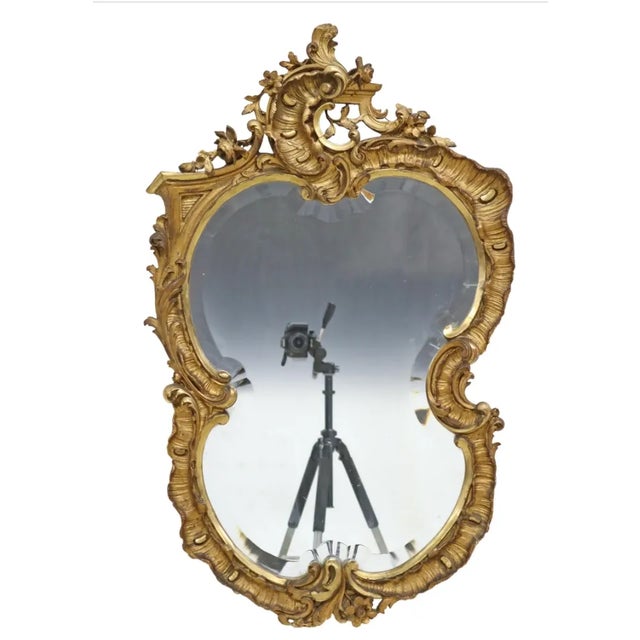 French Louis XV style giltwood and gesso wall mirror, late 19th c., having fanned crest, over shaped frame with scrolled...