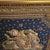 A richly embellished Burmese Kalaga tapestry featuring an elaborately costumed figure riding a ceremonial elephant,...