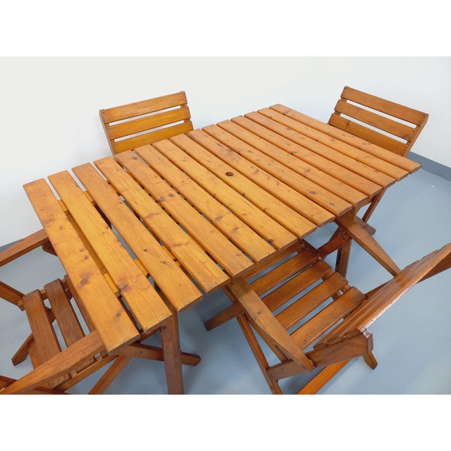 Vintage 1960s Scandinavian-style garden furniture set, consisting of a rectangular table with a parasol hole and four...