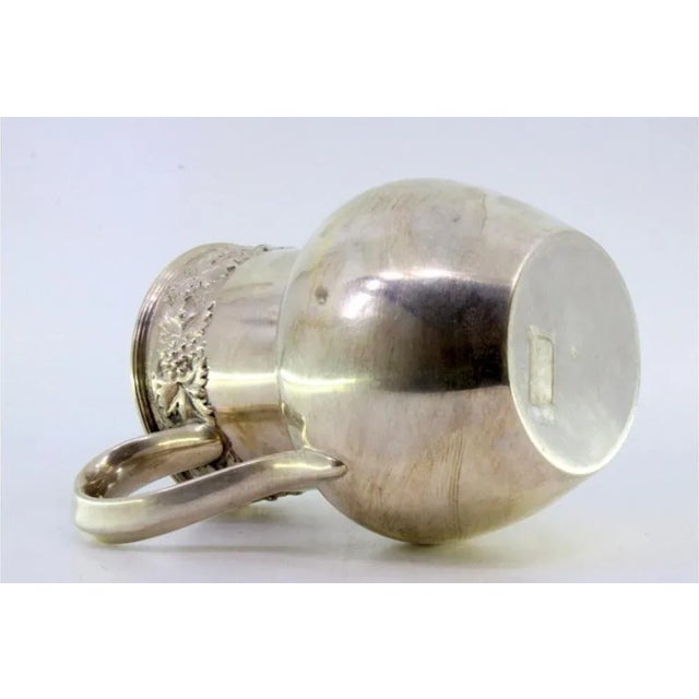 Silver Wine Jug with Reliefs and Applications of Leaves and Grapes, in Very Good conditions. Designed from 2000 This piece...