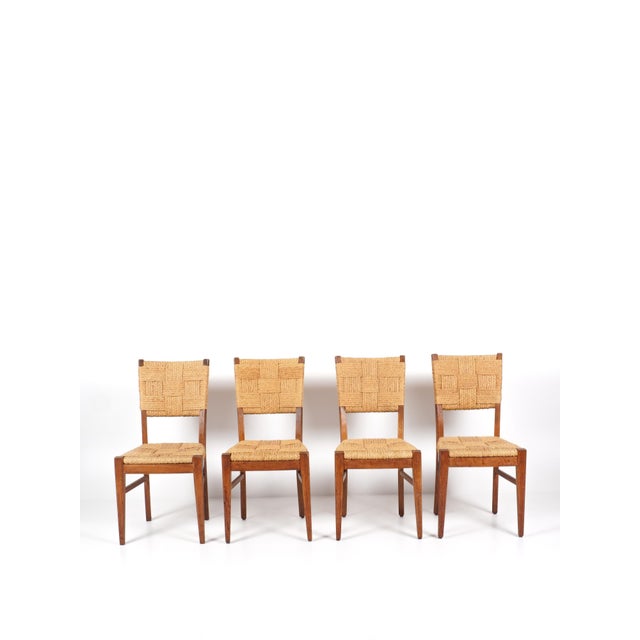 Audoux & minet set of 4 chairs france, circa 1950 oak & rope h: 88 cm / w: 46 cm / d: 42 cm excellent overall condition....