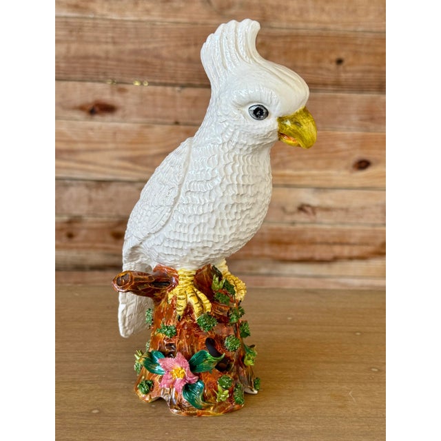 Charming mid-20th century Italian Majolica ceramic figurine of a white cockatoo perched on a colorful floral tree stump....