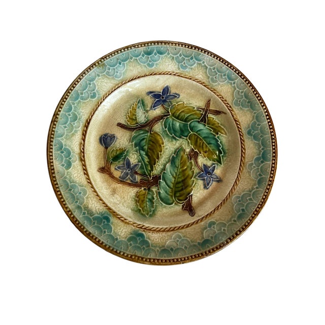 French Majolica plates, a refined pair showcasing richly glazed earthenware with classic French decorative tradition. The...