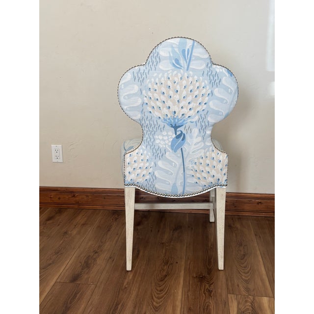 Elevate your space with this stunning Ambella Home scalloped accent chair, blending classic elegance with breezy coastal...