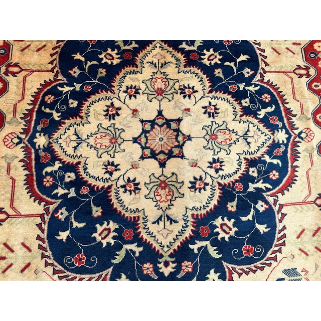 This hand-knotted heriz rug uses natural colors and handspun wool. This lovely rug will enhance your home's style. This...