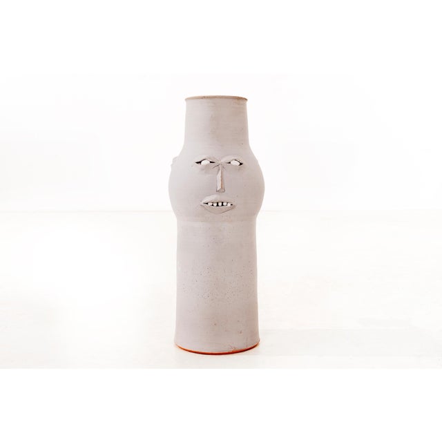 Clyde Burt stylized face vase in matte gray glazed stoneware with manipulated and applied facial details. Signed to...