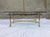 Vintage French hollywood regency style brushed brass base, 5/8” thick rounded edge elliptical glass top coffee table,...