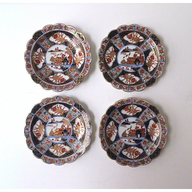 A set of four (4) Japanese export porcelain plates with scalloped edges, in the Chinoiserie design style/Imari‑style...