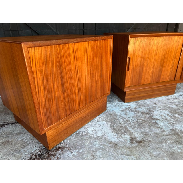 Gorgeous Danish modern teak side tables or nightstands with beautiful tambour doors. Fabulous wood grain patterns…nature’s...