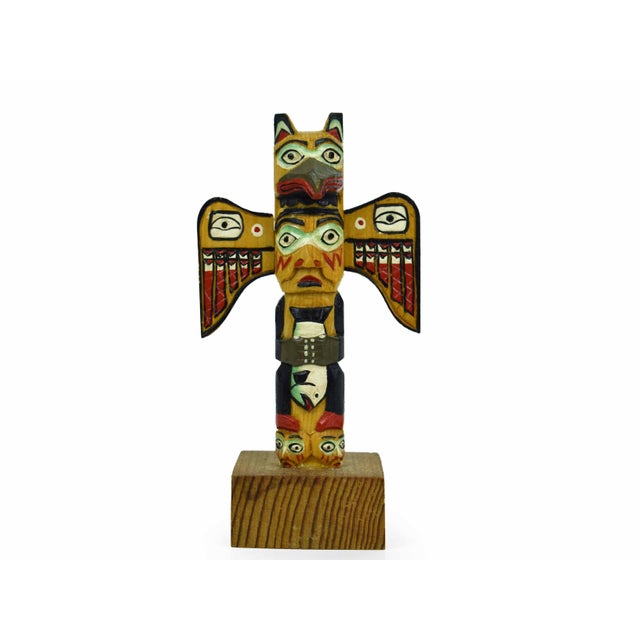 This striking hand-carved totem pole is a masterfully crafted piece of Southeast Alaska Native art, carved from authentic...