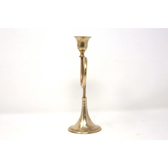 A vintage, brass candle holder, in the form of a horn or trumpet. Good condition; natural patina.
