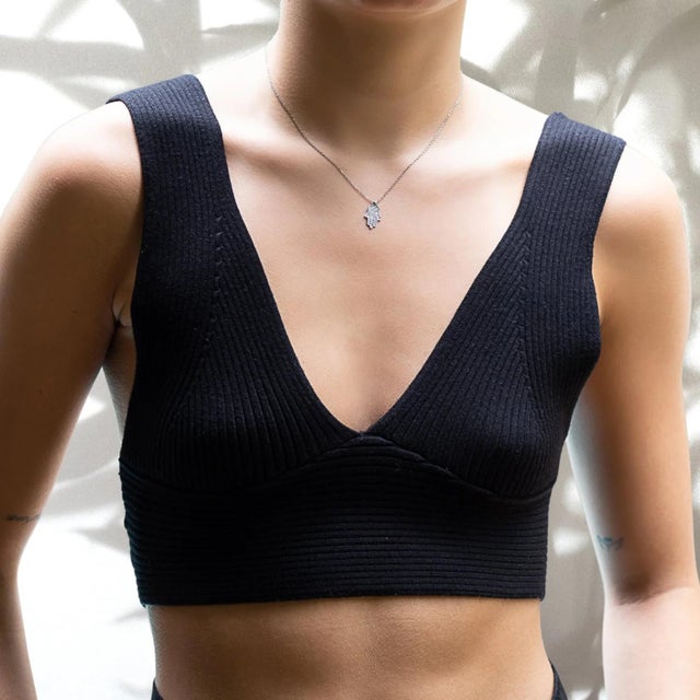 The Dainty Diamond Hamsa Pendant Sterling Silver Chain Necklace, a symbol of protection and good luck that is sure to add...