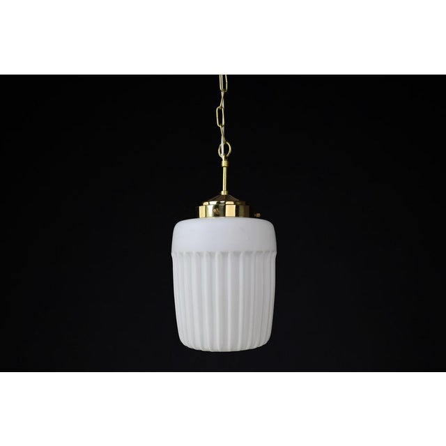 1970s european mid-century modern opaline glass & brass pendant lights – set of six available a beautiful blend of...