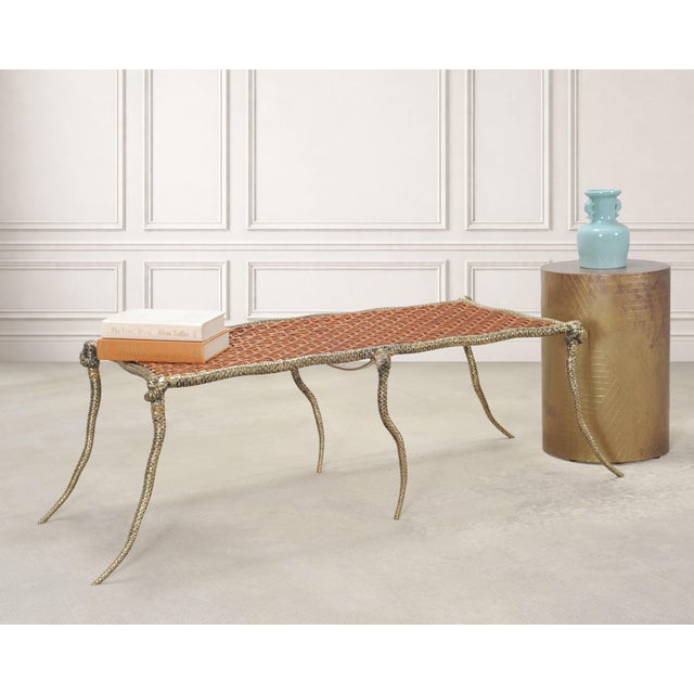 An exceptional and rare cast brass and woven leather serpentine "Viper" coffee table or bench designed by Sylvan Fiss for...