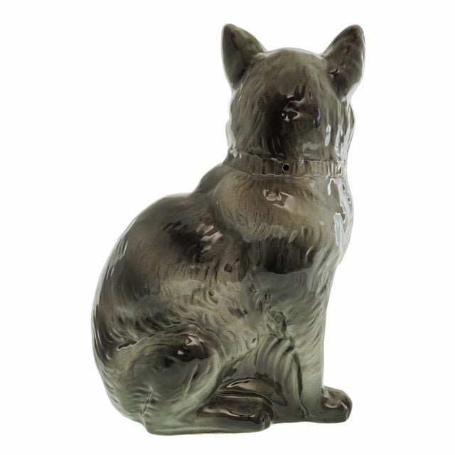 A charming antique Staffordshire pottery cat, modeled at life size and seated in a classic, alert pose. It features a...