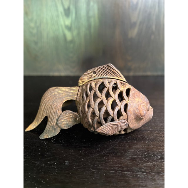 This unique vintage cast iron fish lantern exhibits a charming patina, making it an exquisite piece for collectors or...
