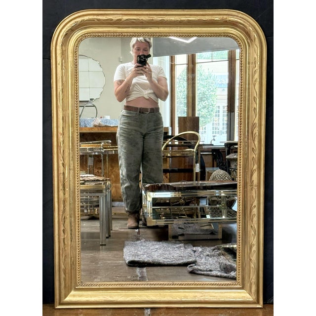 A fine large Louis Philippe arch top wall mirror from France, featuring a moulded surround with a beautiful patinated...