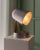 German vintage design at its Best, rotated aluminum shade, 3D cut, open and curved, this table lamp brings warm light to...