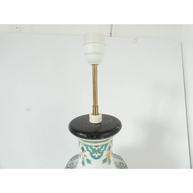 Vintage Ceramic floral turquoise chinoiserie style lamp base on a wooden pedestal. There is a floral and bird motif which...