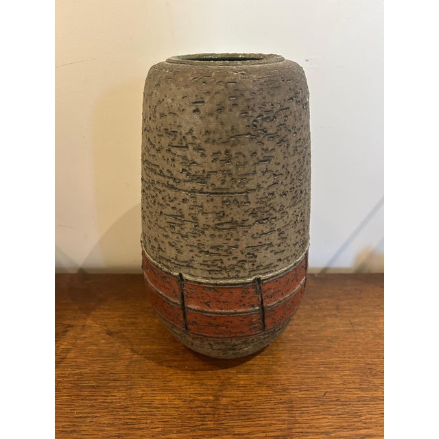 This handmade vase was produced by Spara Keramik in the 1960s/1970s. A German workshop ceramic vase with a red and gray...