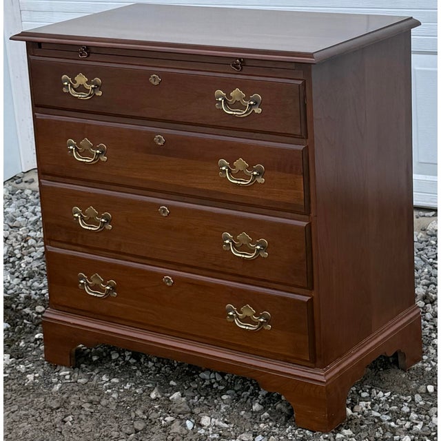 Classic solid cherry bachelors chest circa late 20th century. Features four dovetailed drawers, bracket feet, solid brass...