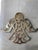 This vintage pair of silverplate angel trivets features pierced scrollwork bodies, smiling faces, and outstretched wings....