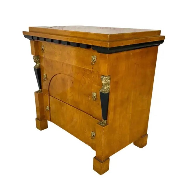 Biedermeier Style Neoclassical Chest of Drawers. Chest features three ample drawers with gilded brass lion pulls and...