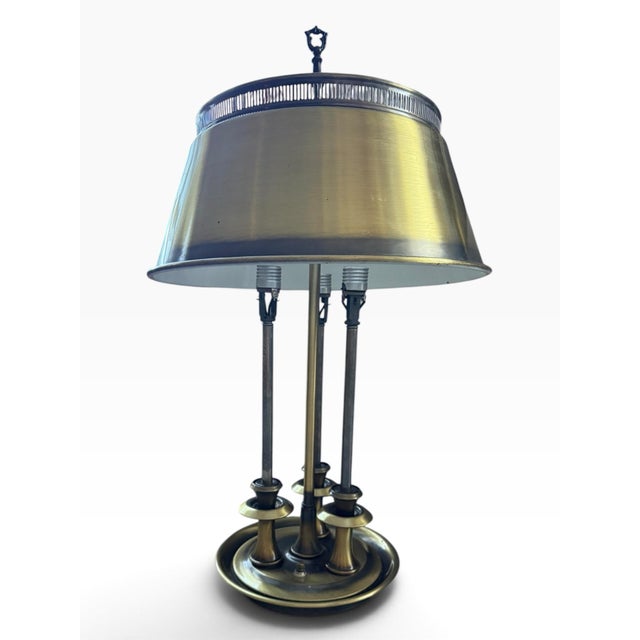Striking vintage 1970s bouillotte-style table lamp featuring a sculptural three-light form in brass and darkened metal,...