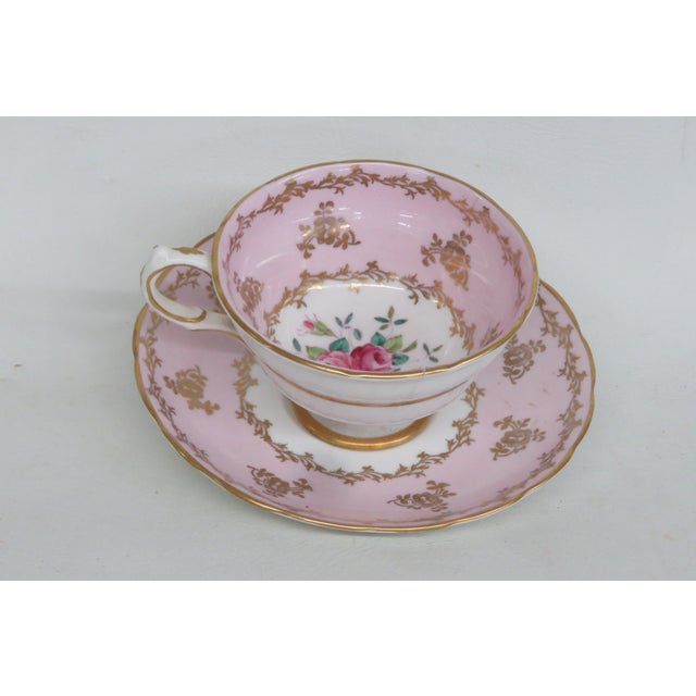 This beautiful footed teacup and saucer has the maker's mark "Grovenor", England" Jackson & Gosline on the underneath. The...