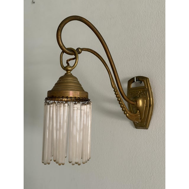 Pair of brass and crystal teardrop wall sconces, original period pieces. Art Nouveau/Early Art Deco style. Circa...