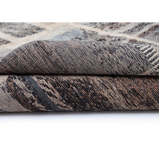 Artistic Moroccan hand-knotted wool rug showcasing layered shades of Ultimate Gray, Cool Gray, Charcoal, Niagara Mist,...