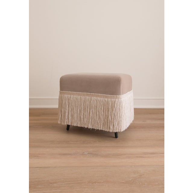 The Hutton is a cotton velvet upholstered stool, finished with a fringe trim in Dune. Crafted from richly variegated...