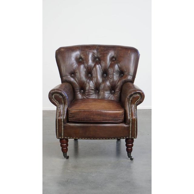 A beautiful, unique cognac-colored brown grained cowhide leather chesterfield armchair/armchair. This beautiful, classic,...