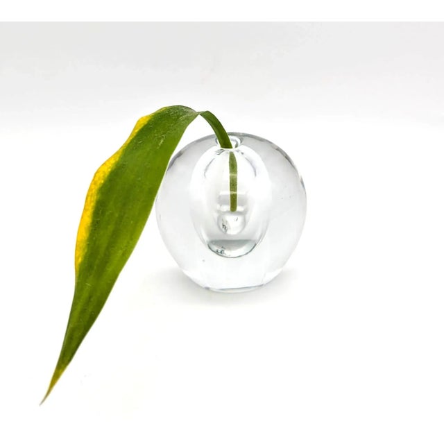 Offered is a transparent blown glass paper weight made in Poland, circa. 1980s. It has a flat round base that is 1.875" in...