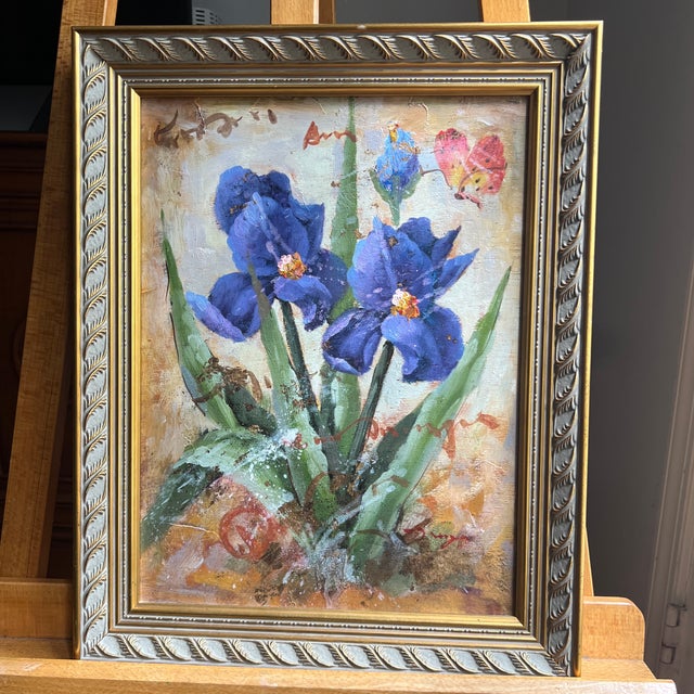 Oil on canvas impressionist style still life floral Ireses and butterfly framed and signed . It comes from an art...