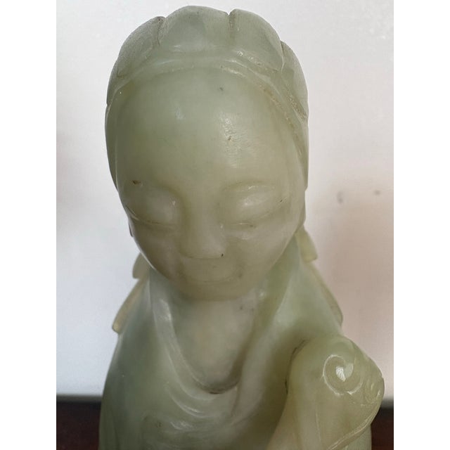 Gorgeous stone sculpture of Guanyin, known as the goddess of mercy or compassion The figure is carved from a pale green...