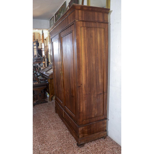 Wardrobe 2 doors and 2 drawers and onion feet made of solid walnut with veneered parts. Italy second half of 1800...