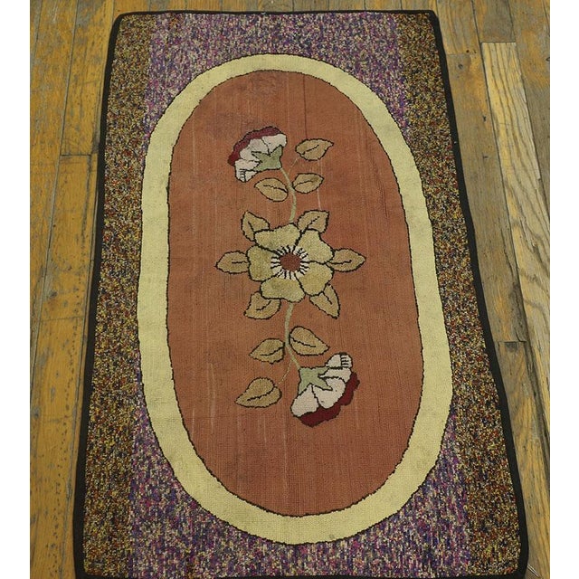 Antique American hooked rug, size: 1'9" x 3'0". This charming, small antique American floral hooked rug showcases the...