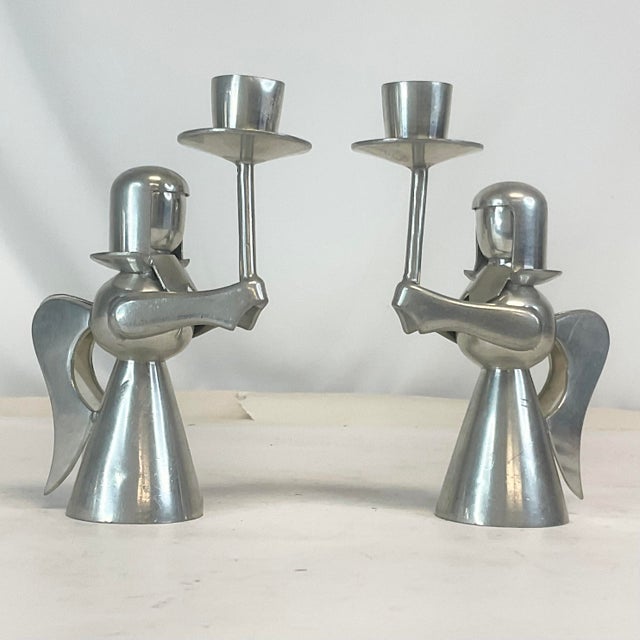 This is a delightful pair of angel candle holders from the 1980s. They are crafted from pewter and feature each angel...
